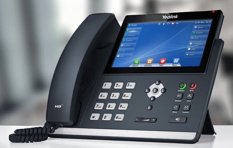 A Yealink business desk phone with a colour touchscreen