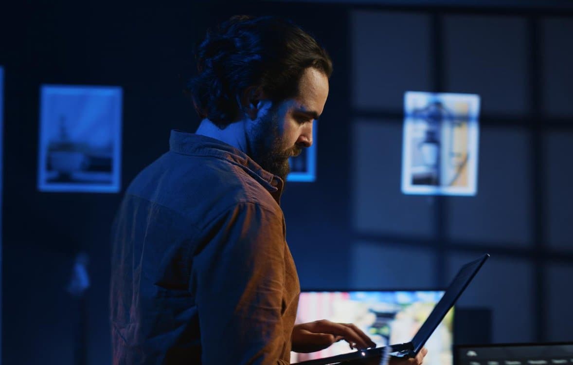 An IT engineer working on a laptop