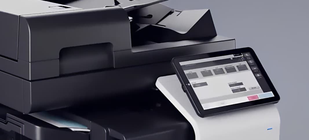 Close-up of a Konica Minolta bizhub multifunction printer touchscreen